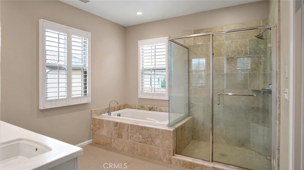 128 Gulfstream Irvine, CA 92620 - Photo 12 of 15 a bathroom with a tub sink shower and mirror