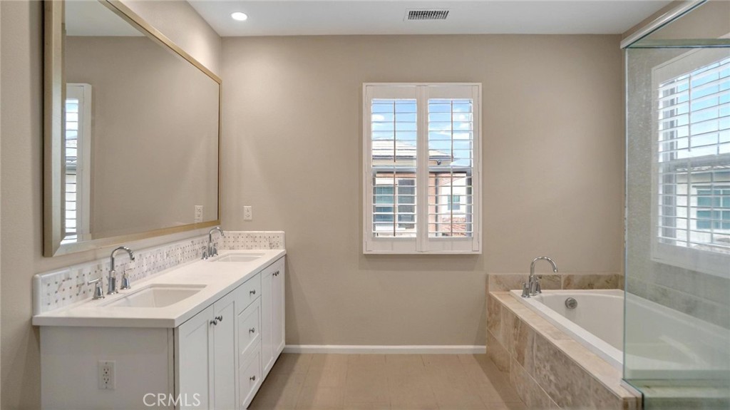 128 Gulfstream Irvine, CA 92620 - Photo 13 of 15 a bathroom with a tub sink and mirror