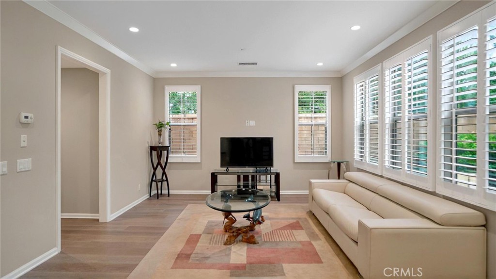 128 Gulfstream Irvine, CA 92620 - Photo 5 of 15 a living room with furniture and a flat screen tv