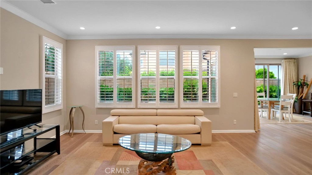 128 Gulfstream Irvine, CA 92620 - Photo 6 of 15 a living room with furniture a flat screen tv and a large window