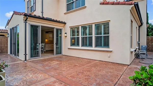 a bedroom with a bed lamp and window