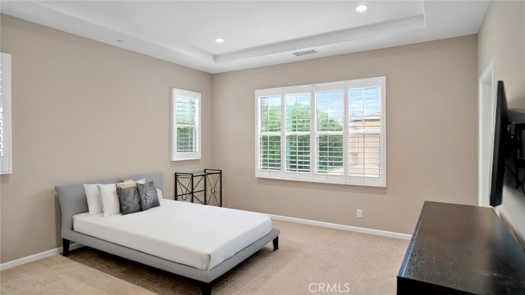 128 Gulfstream Irvine, CA 92620 - Photo 10 of 15 a bedroom with a bed lamp and window