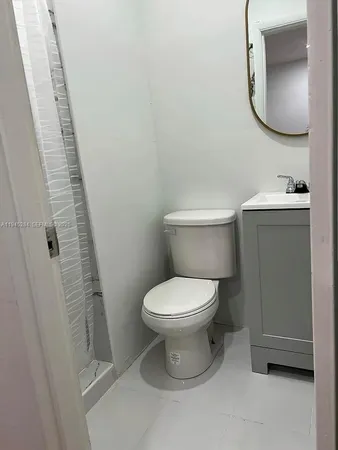 a white toilet sitting next to a bathroom sink