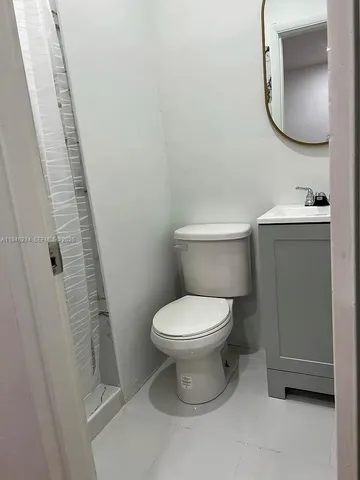 a white toilet sitting next to a bathroom sink