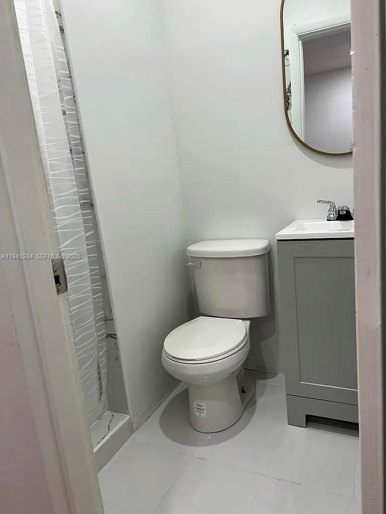 45 West 60th Street Hialeah, FL 33012 - Photo 7 of 11 a white toilet sitting next to a bathroom sink
