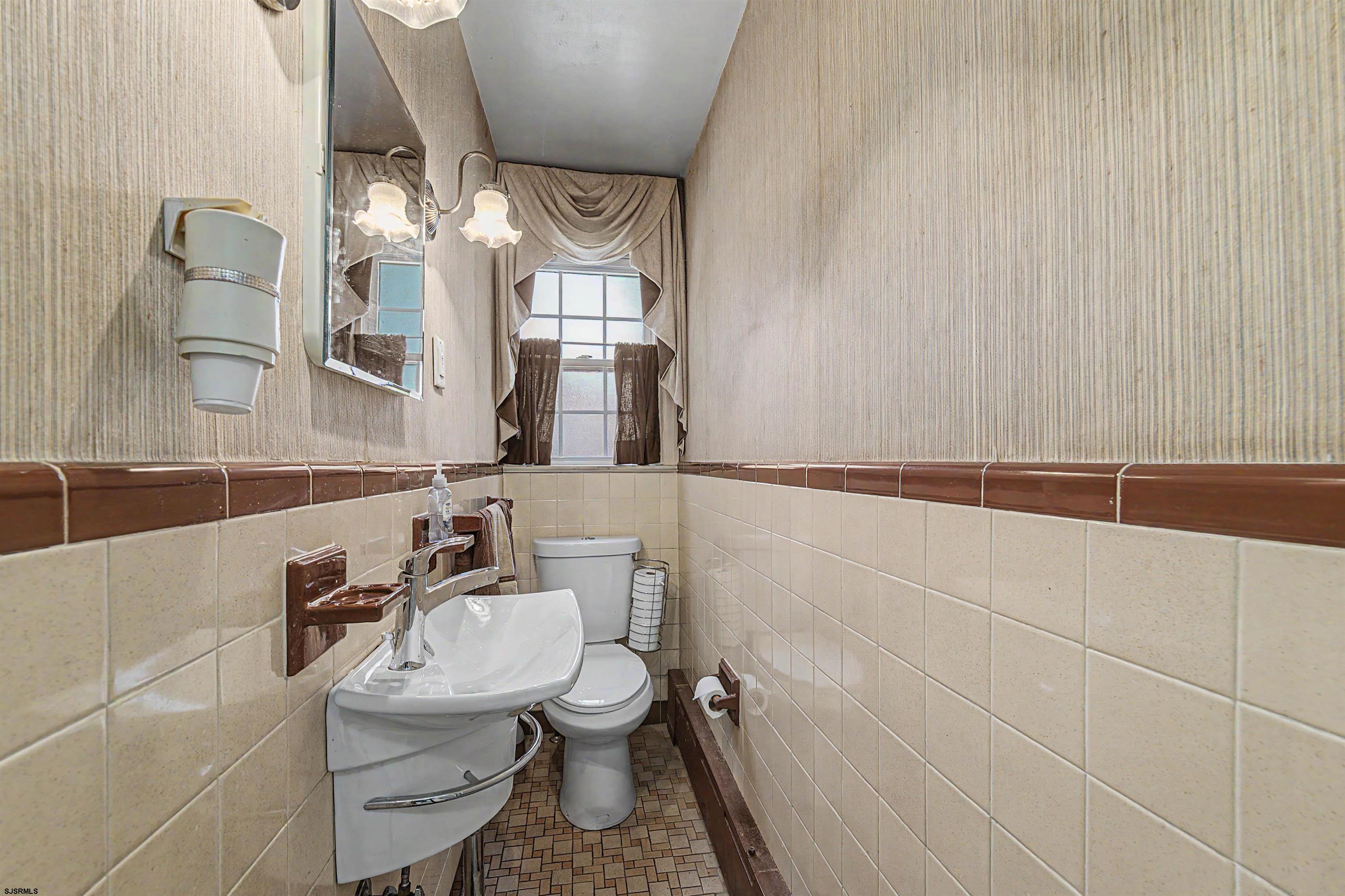 144 Pitney Road Absecon, NJ 08201 - Photo 24 of 47 a bathroom with a toilet a sink and mirror