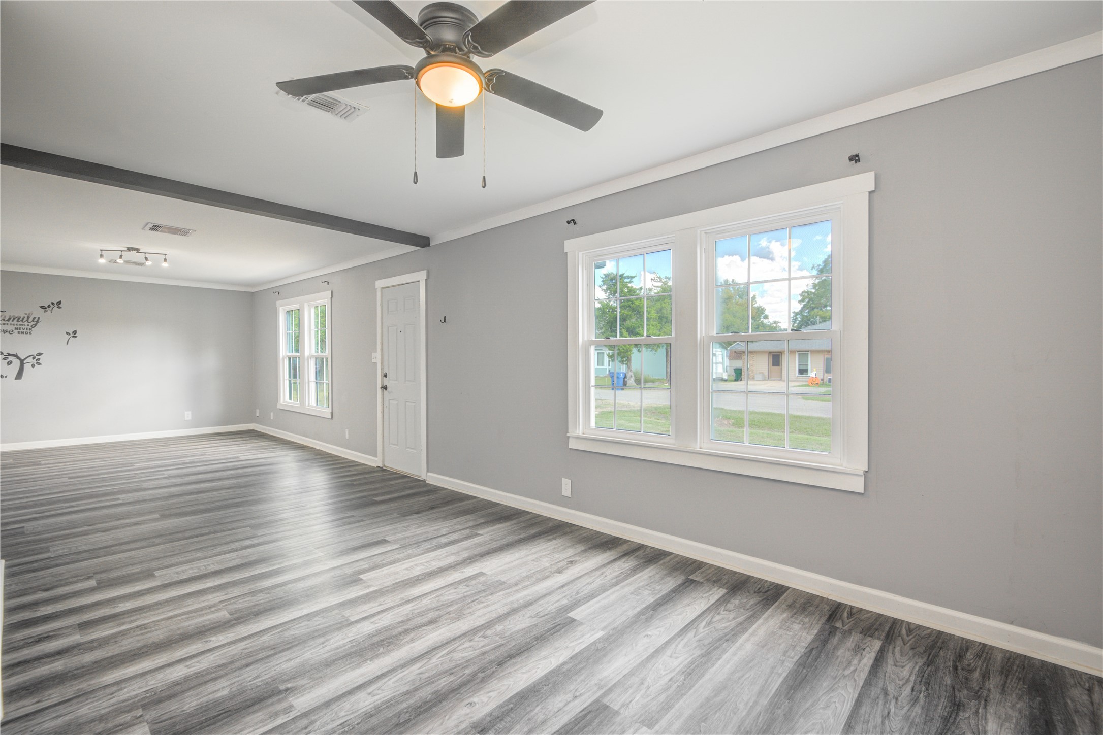 609 Hurst Place Angleton, TX 77515 - Photo 7 of 36 a view of an empty room with wooden floor and a window