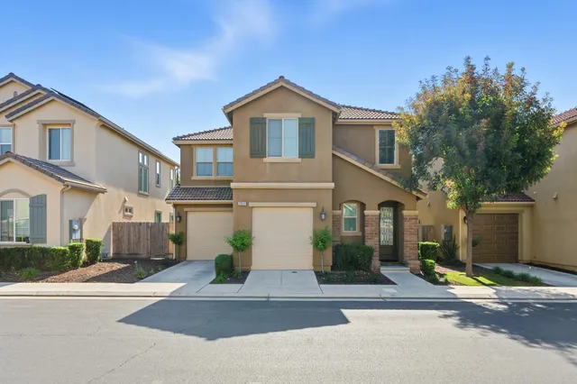 a view of a white house with a street