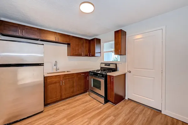 a kitchen with stainless steel appliances a stove sink and cabinets