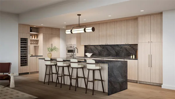 a kitchen with stainless steel appliances kitchen island granite countertop a table chairs and a refrigerator