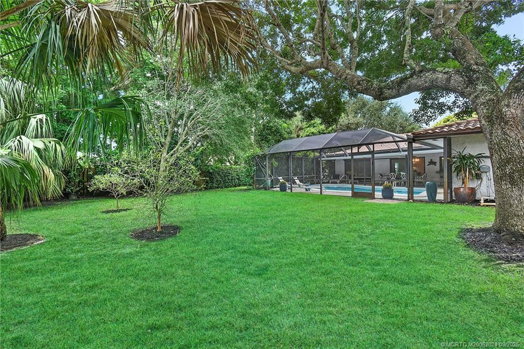 6 Copaire Road Sewall's Point, FL 34996 - Photo 13 of 76 a view of a house with a backyard