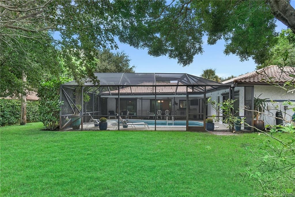 6 Copaire Road Sewall's Point, FL 34996 - Photo 14 of 76 a view of a house with a yard and sitting area