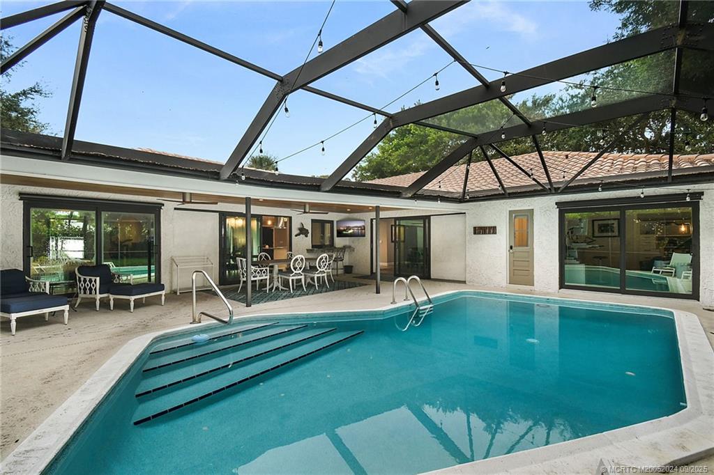 6 Copaire Road Sewall's Point, FL 34996 - Photo 17 of 76 a swimming pool with outdoor seating and yard