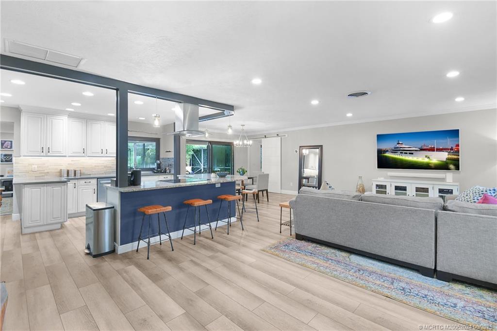 6 Copaire Road Sewall's Point, FL 34996 - Photo 23 of 76 a living room with furniture and a flat screen tv