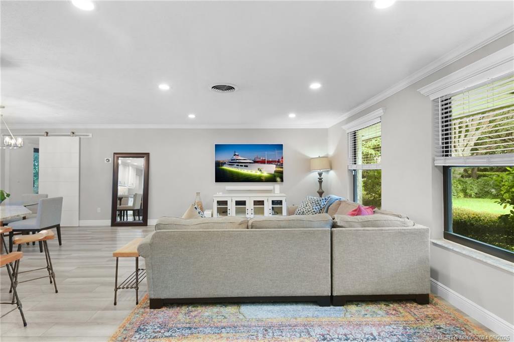 6 Copaire Road Sewall's Point, FL 34996 - Photo 24 of 76 a living room with furniture and a flat screen tv