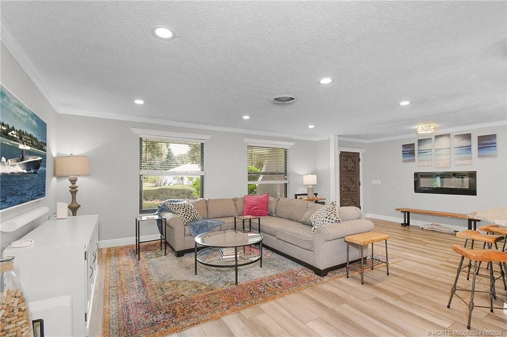 6 Copaire Road Sewall's Point, FL 34996 - Photo 31 of 76 a living room with furniture and a flat screen tv