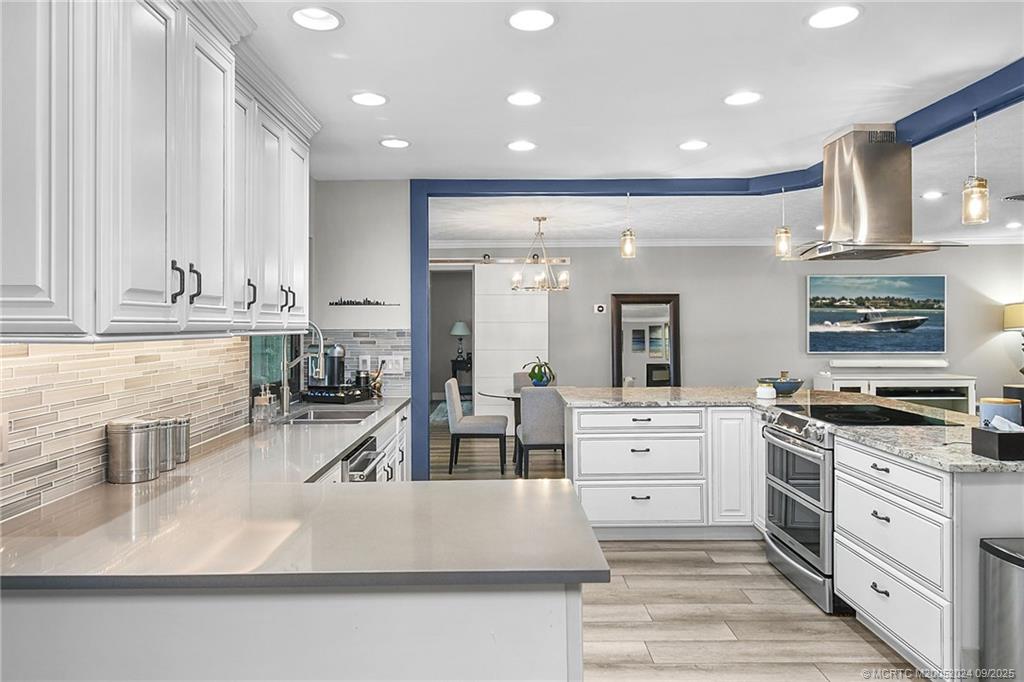 6 Copaire Road Sewall's Point, FL 34996 - Photo 34 of 76 a large kitchen with stainless steel appliances granite countertop a lot of counter space and a sink