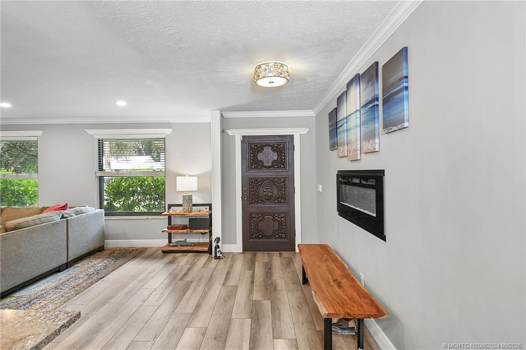 6 Copaire Road Sewall's Point, FL 34996 - Photo 36 of 76 a living room with furniture and a wooden floor