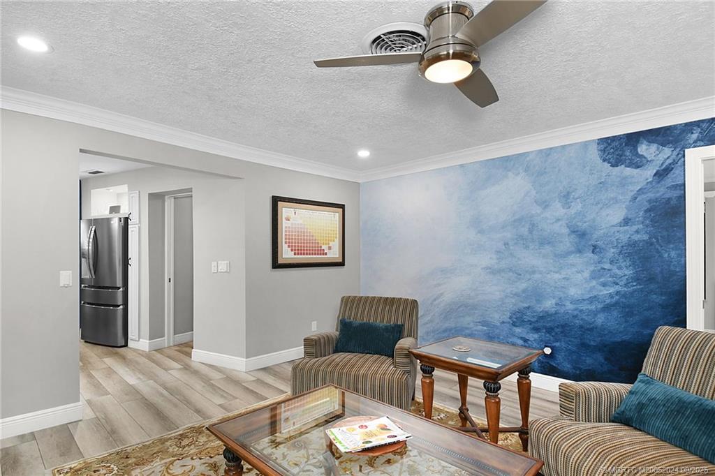 6 Copaire Road Sewall's Point, FL 34996 - Photo 40 of 76 a living room with furniture and a ceiling fan