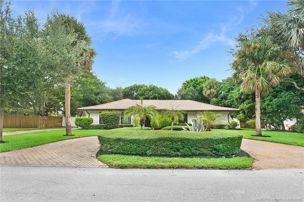 6 Copaire Road Sewall's Point, FL 34996 - Photo 4 of 76 a view of a house with a yard and potted plants