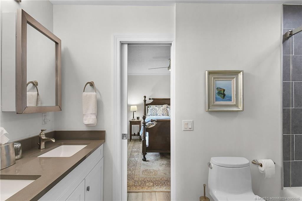 6 Copaire Road Sewall's Point, FL 34996 - Photo 41 of 76 a bathroom with a sink vanity and a toilet