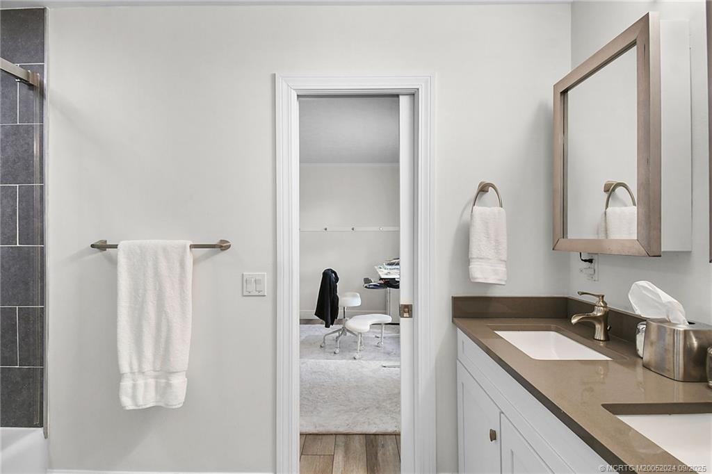 6 Copaire Road Sewall's Point, FL 34996 - Photo 43 of 76 a bathroom with a sink vanity and mirror