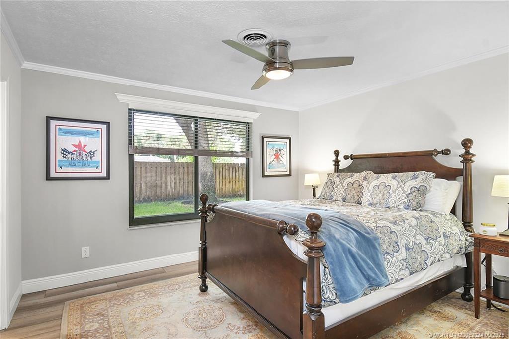 6 Copaire Road Sewall's Point, FL 34996 - Photo 45 of 76 a bedroom with a bed and a window