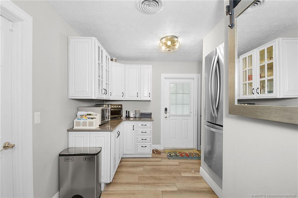 6 Copaire Road Sewall's Point, FL 34996 - Photo 51 of 76 a room with stainless steel appliances a refrigerator and a cabinets