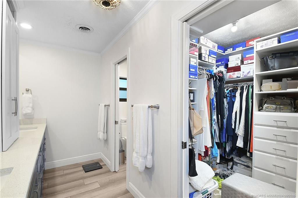 6 Copaire Road Sewall's Point, FL 34996 - Photo 58 of 76 a view of walk in closet with clothes and shoes