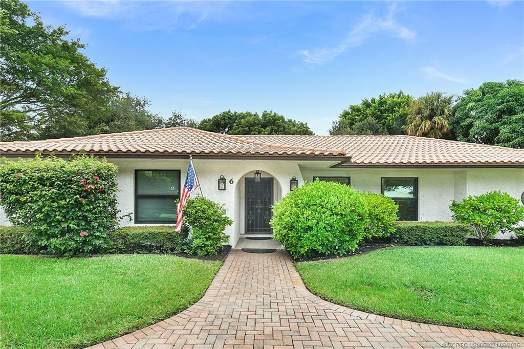 6 Copaire Road Sewall's Point, FL 34996 - Photo 6 of 76 a front view of a house with garden