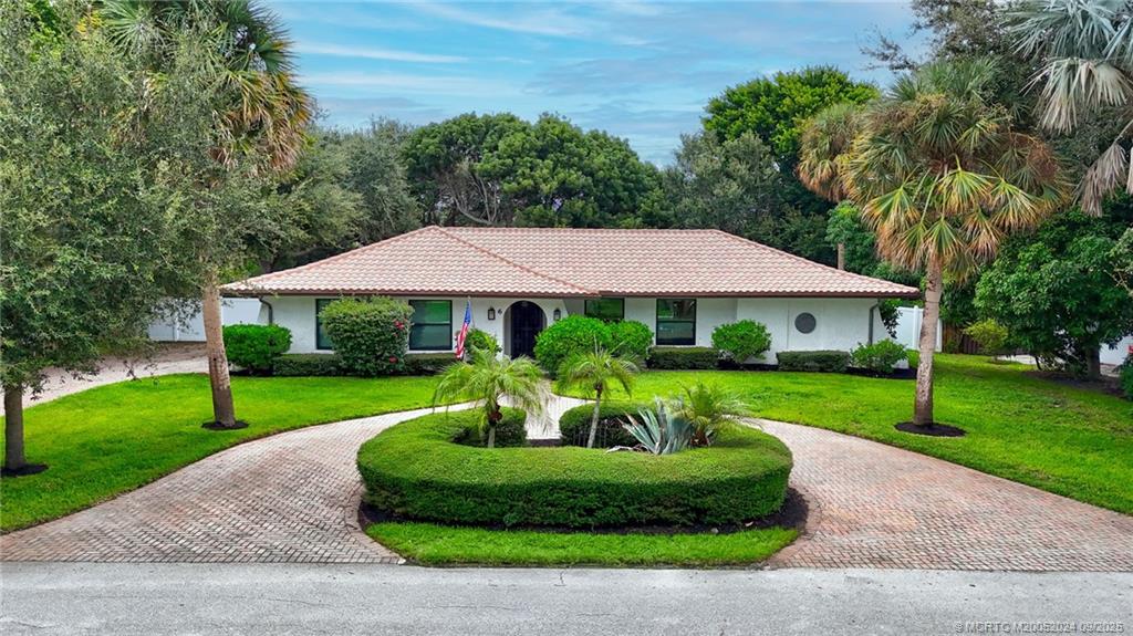 6 Copaire Road Sewall's Point, FL 34996 - Photo 62 of 76 a front view of a house with a yard table and chairs