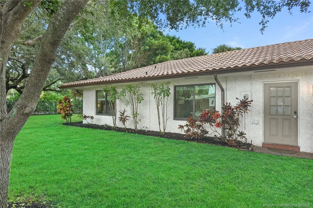 6 Copaire Road Sewall's Point, FL 34996 - Photo 10 of 76 a view of a house with backyard and porch