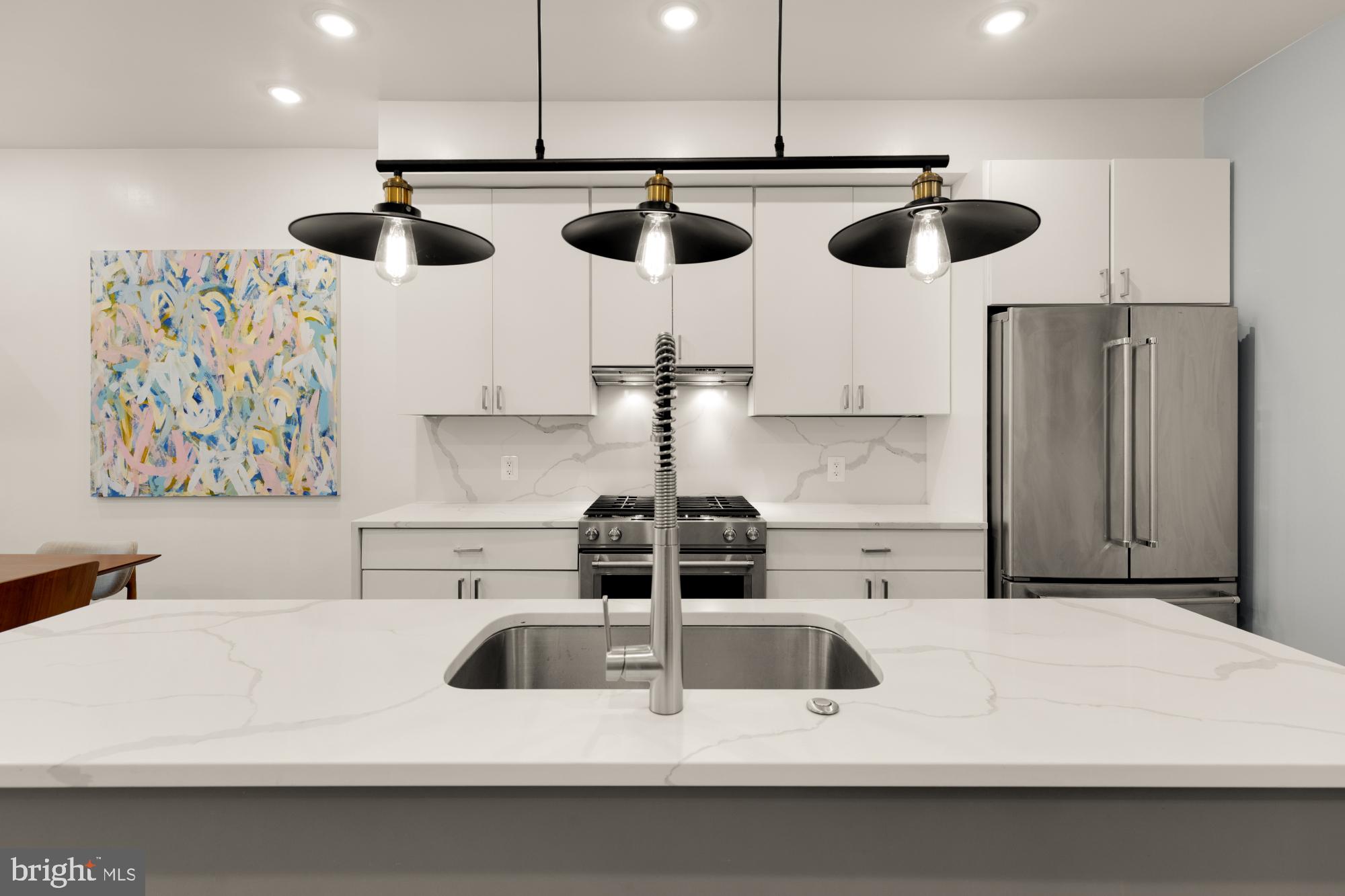 81 U Street Northwest, Unit A Washington, DC 20001 - Photo 13 of 46 a kitchen with a refrigerator and chairs