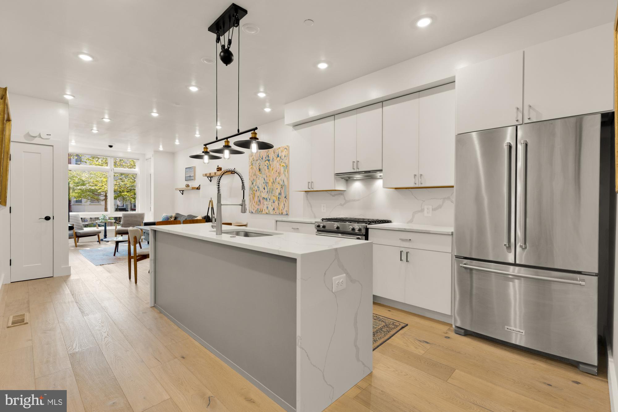 81 U Street Northwest, Unit A Washington, DC 20001 - Photo 14 of 46 a kitchen with kitchen island a counter top space a sink stainless steel appliances and cabinets