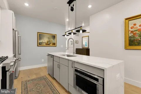 a kitchen with a sink appliances and cabinets
