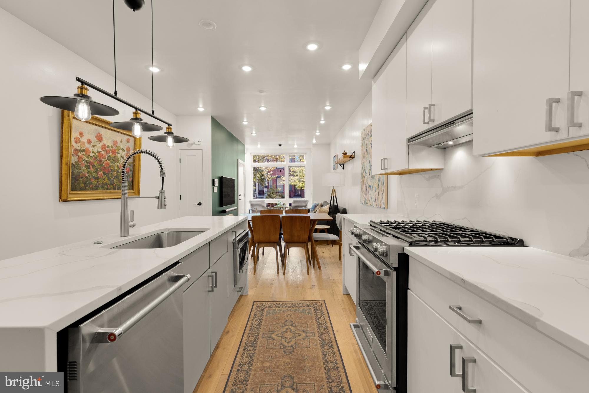 81 U Street Northwest, Unit A Washington, DC 20001 - Photo 18 of 46 a kitchen with stainless steel appliances granite countertop a sink a stove and a wooden floors