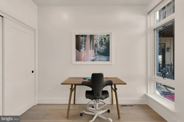 a work room with furniture and a window
