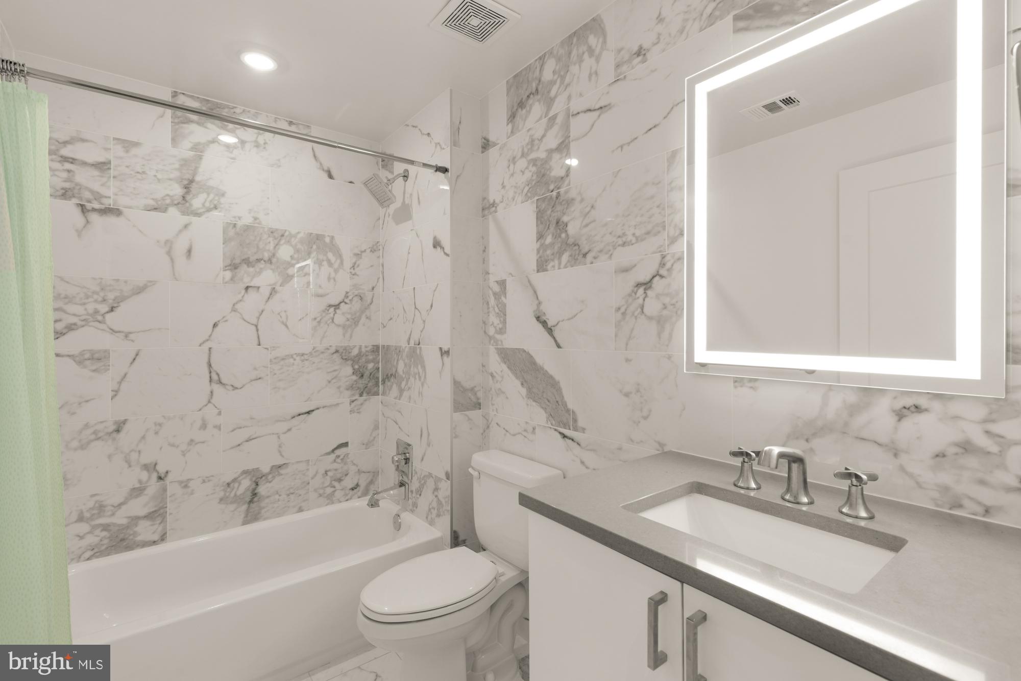 81 U Street Northwest, Unit A Washington, DC 20001 - Photo 30 of 46 a bathroom with a granite countertop sink toilet and shower