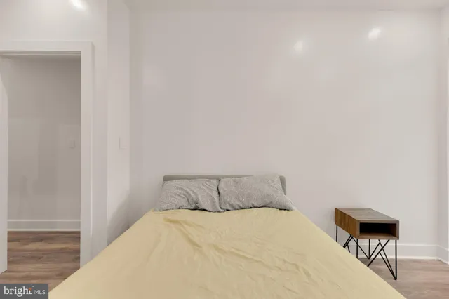 a bedroom with a bed and a potted plant