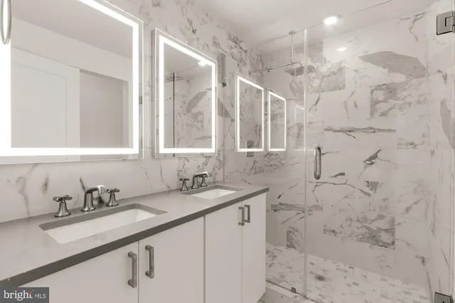 a bathroom with a sink shower and a mirror