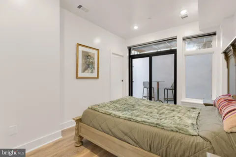 a bedroom with a large bed and a window