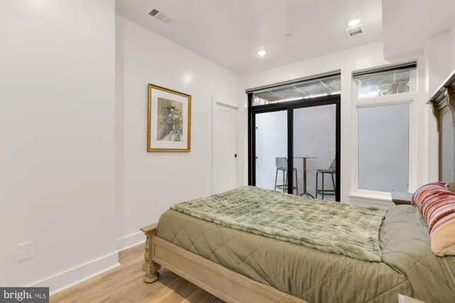 a bedroom with a large bed and a window