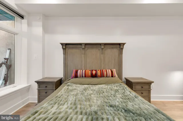 a bedroom with a bed and a window