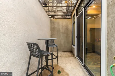 a view of a hallway with a dining table and a chandelier