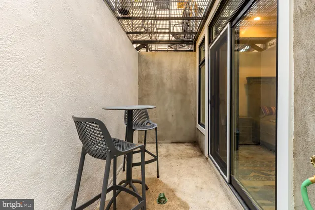 a view of a hallway with a dining table and a chandelier