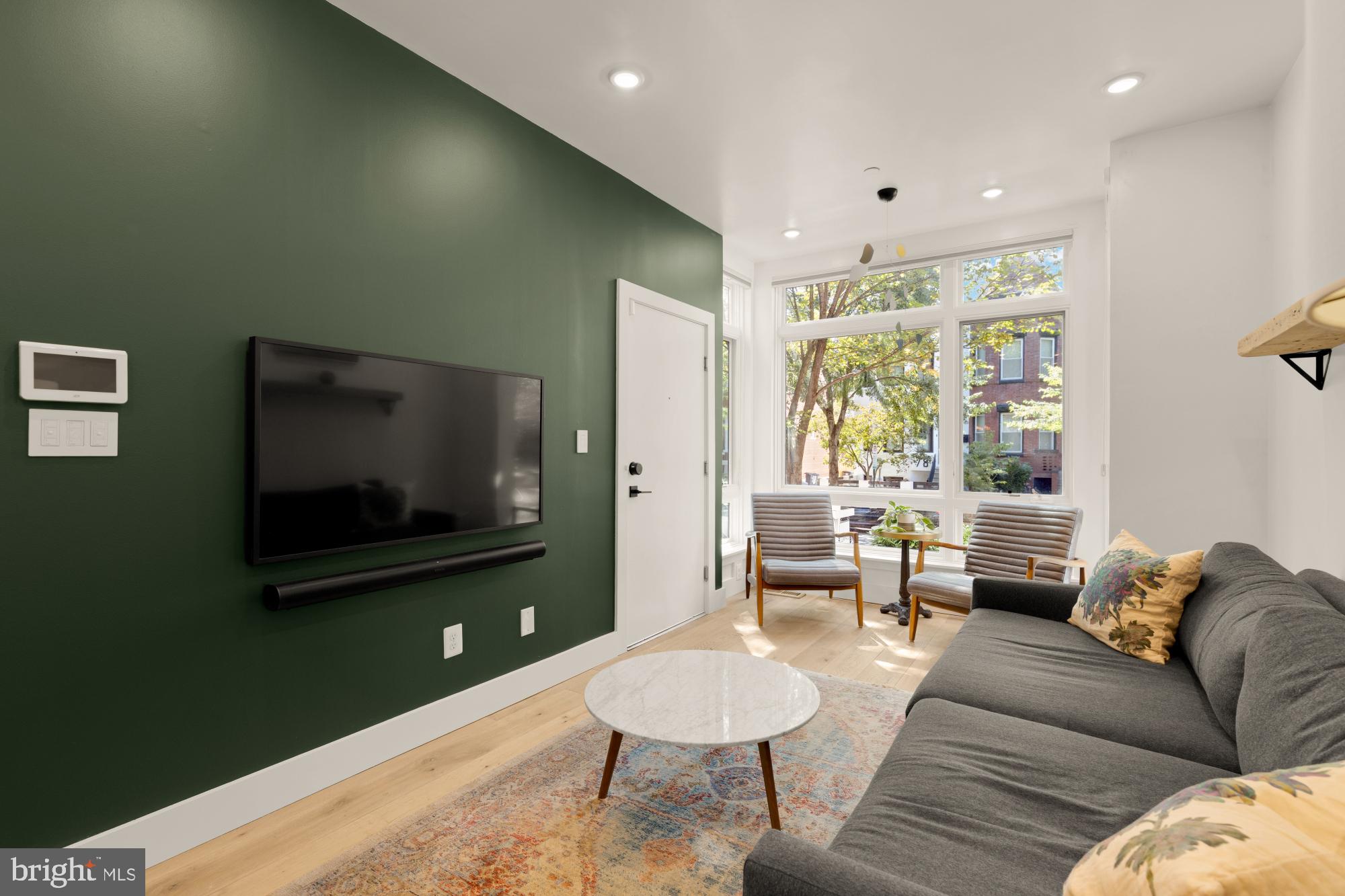 81 U Street Northwest, Unit A Washington, DC 20001 - Photo 6 of 46 a living room with furniture and a flat screen tv