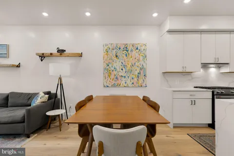 a kitchen with stainless steel appliances granite countertop a sink a stove and a refrigerator