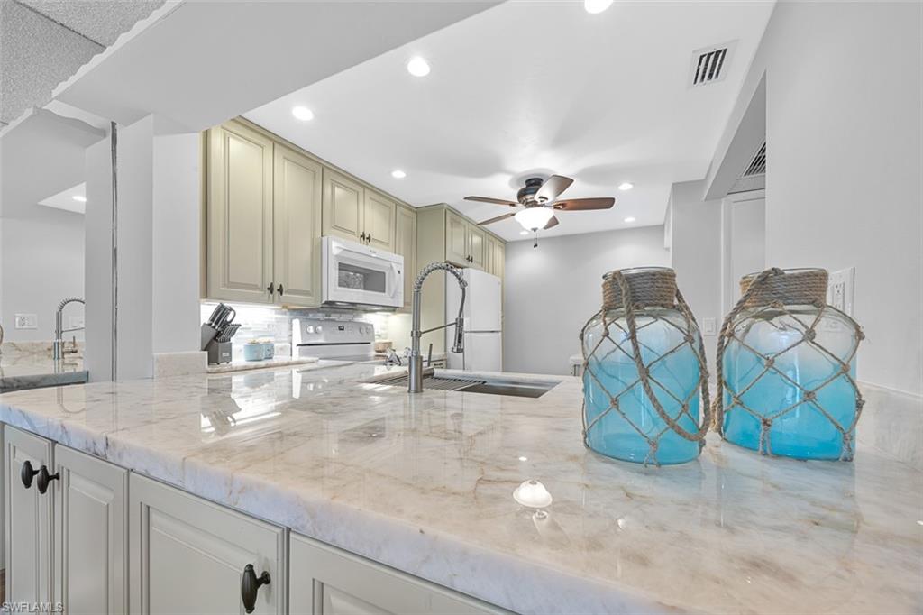 1083 Forest Lakes Drive, Unit 207 Naples, FL 34105 - Photo 1 of 21 a kitchen with lots of counter top space and cabinets