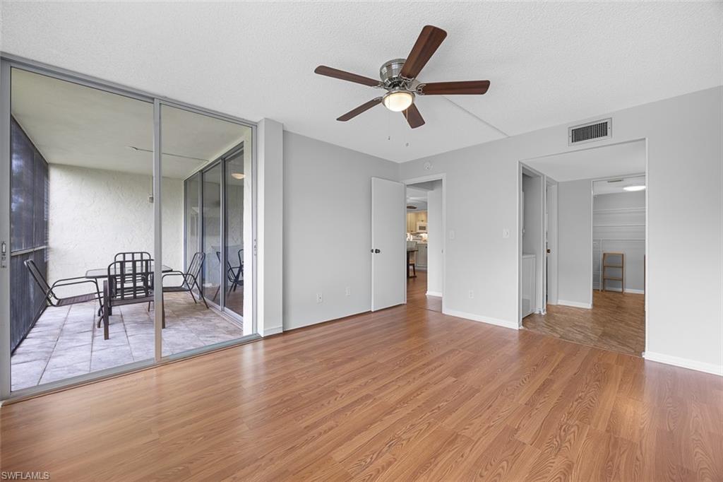 1083 Forest Lakes Drive, Unit 207 Naples, FL 34105 - Photo 11 of 21 a view of a livingroom with a hardwood floor and a ceiling fan
