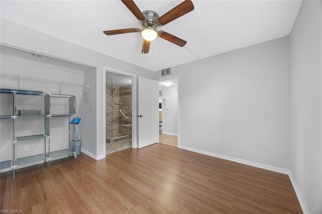 1083 Forest Lakes Drive, Unit 207 Naples, FL 34105 - Photo 13 of 21 an empty room with wooden floor and window
